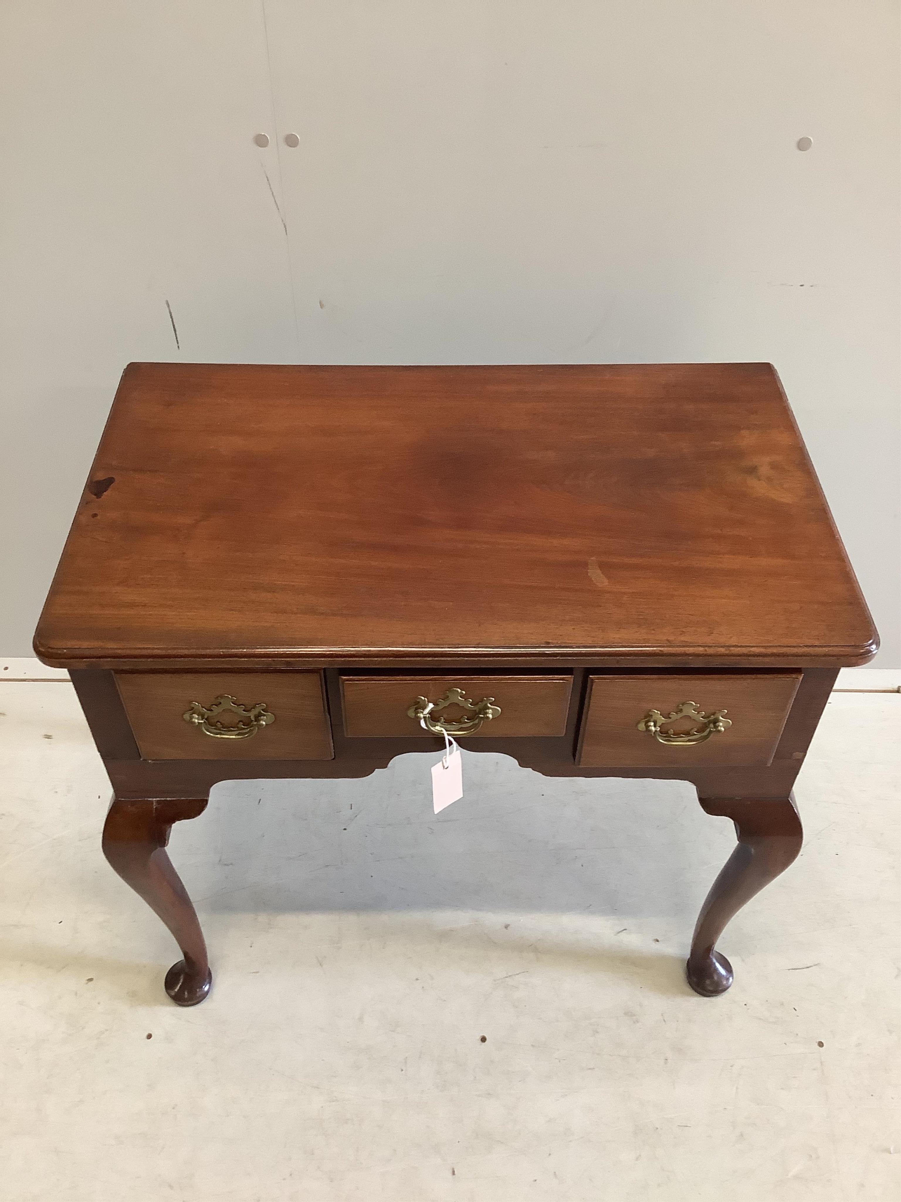 A George III mahogany lowboy fitted three frieze drawers and cabriole pad feet, brass handles, width 76cm, depth 45cm, height 70cm. Condition - fair-good